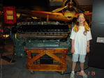 my daughter Emily posing next to an Allison V-1710 engine, as used on the P-38